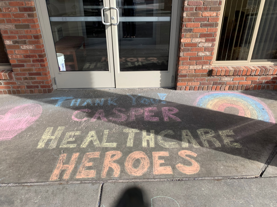 Thank you Healthcare Heroes is written on the sidewalk in chalk